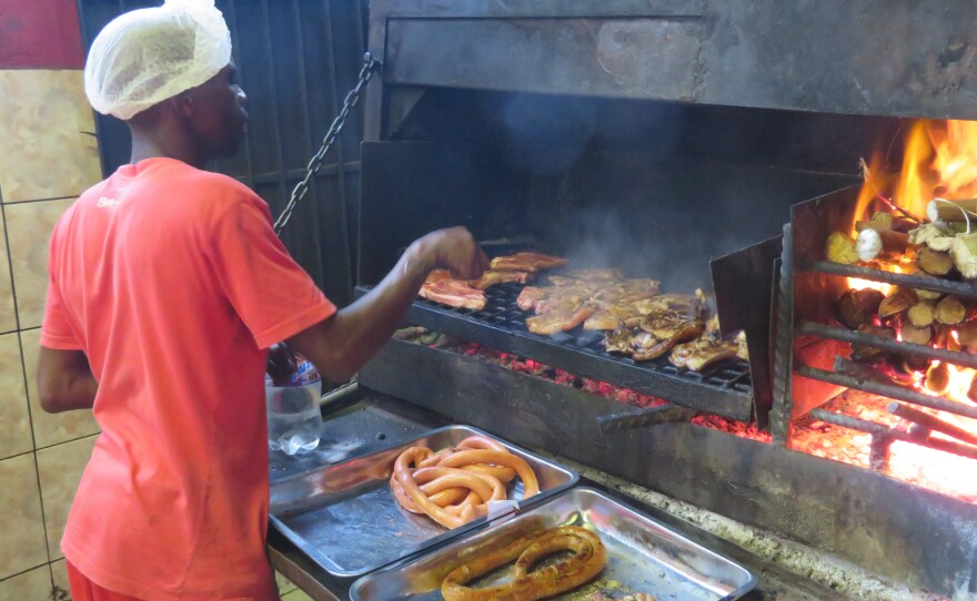 Braai is South African for barbecue. Here, meat is roasted over wood at Mzoli's, a popular butcher and grill in Gugulethu township.
