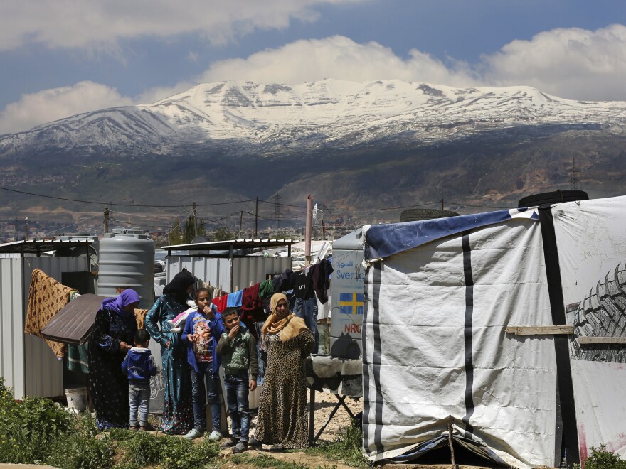 Syrian refugees watch the opening ceremony of a school in the Bekaa valley town of Saadnayel, eastern Lebanon, in April 2019.