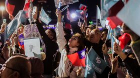 Supporters wave Taiwan's national flags and Taiwan People's Party (TPP) flags during an election campaign rally in Keelung.