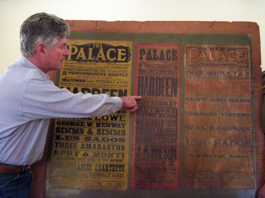 <p>George Hardeen poses with a poster from a 1906 performance by his grandfather, Theo Hardeen. It is the only memento he has of his grandfather. </p>