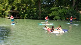 A group of people swimming on Lake Placid. 