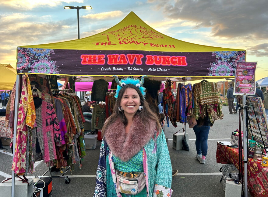 Alena Horowitz stands in front of her booth at the night market and street fair.
