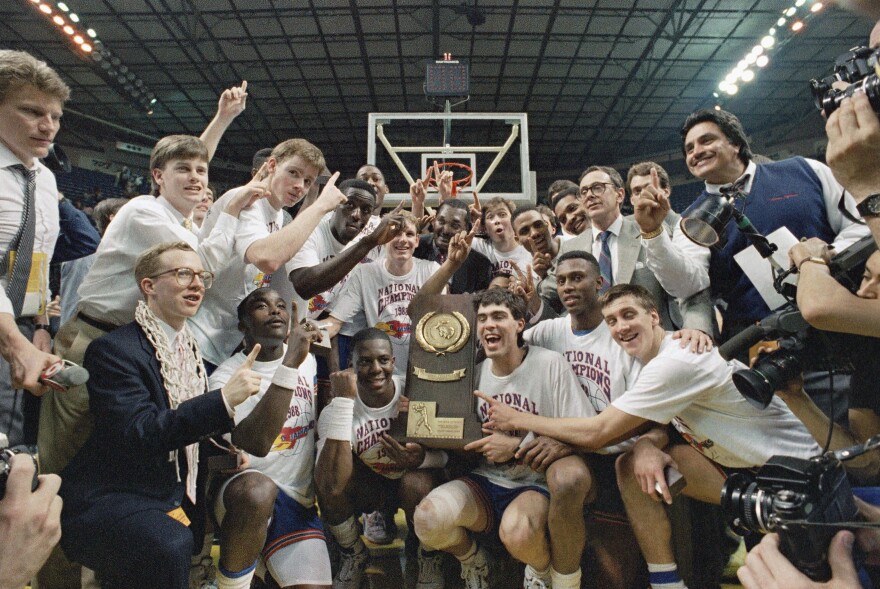 The 1988 Kansas Jayhawks hold up their trophy after winning the championship game of the NCAA Final Four Tournament.