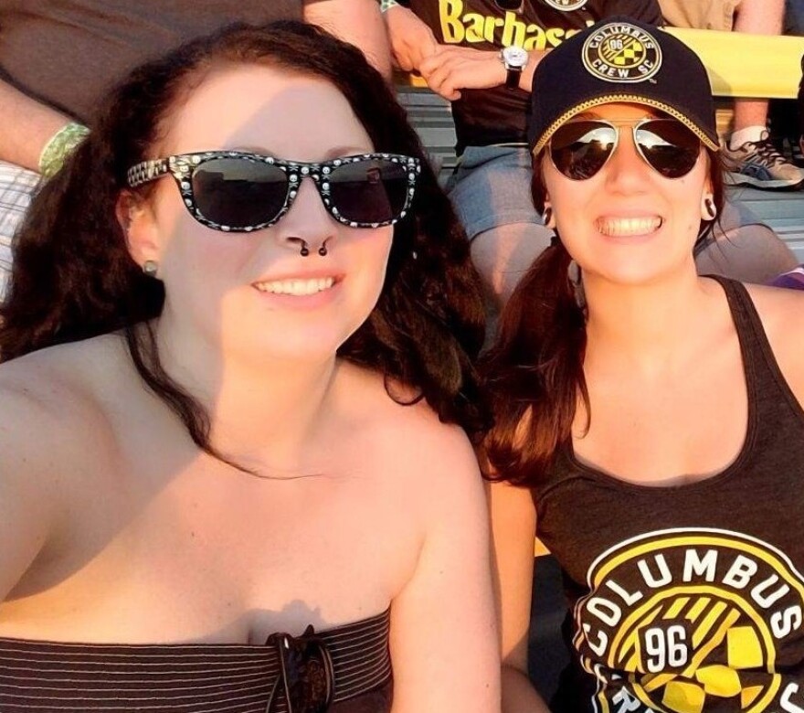 Amanda Wisniewski (right) and friend Caitlin Wingfield, who she met on the job, enjoy a Columbus crew game.