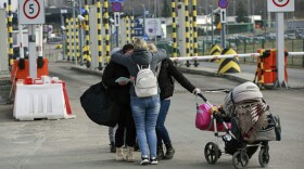 Family members hug as they reunite, after fleeing conflict in Ukraine, at the Medyka border crossing, in Poland, Sunday, Feb. 27, 2022. (AVisar Kryeziu/AP)