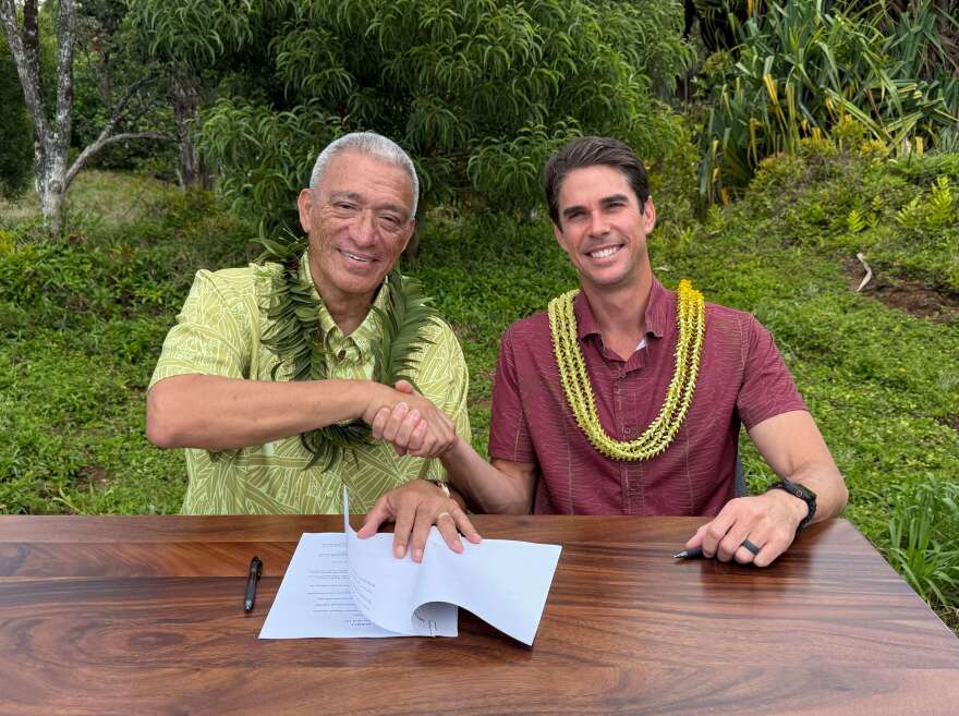 Maui County Mayor Richard Bissen, left, and Maui Land & Pineapple Company CEO Race Randle, right, have signed a memorandum of understanding for the county's acquisition of key West Maui water systems.