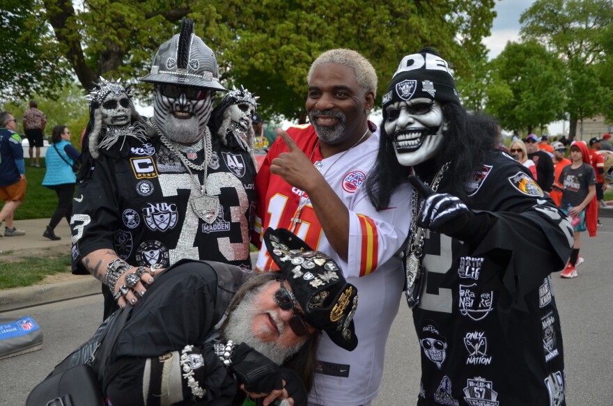 Kansas City Chiefs and Las Vegas Raiders fans put their rivalry aside to pose for a photo.