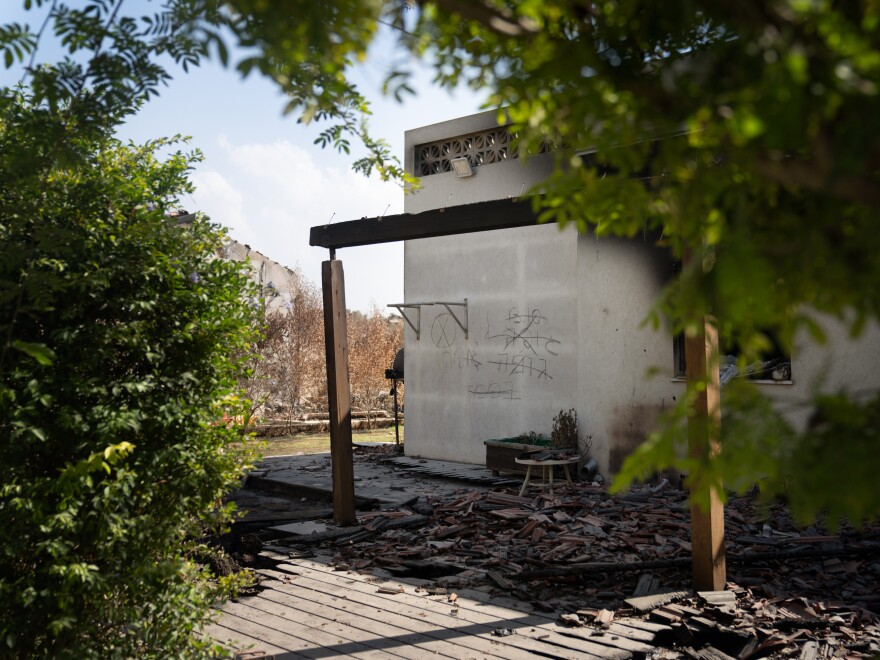 An Israeli search and recovery team marked the wall of a house in Kibbutz Be'eri with the number of bodies they found.