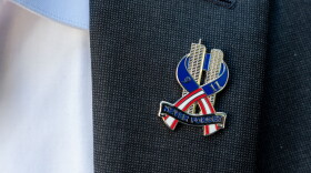 Brett Eagleson, 40, President of 9/11 Justice, wears a 9/11 pinduring a press conference demanding accountability regarding the Kingdom of Saudi Arabia's role in the 9/11 terrorist attacks, Tuesday, Sept. 8, 2026, in New York. (AP Photo/Adam Gray)
