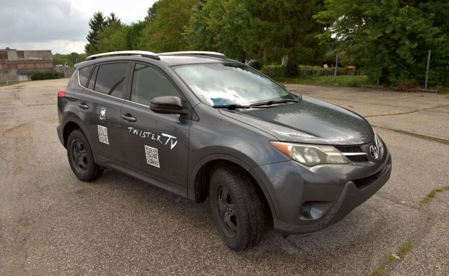 Grey Toyota with "Twister TV" logo on its side
