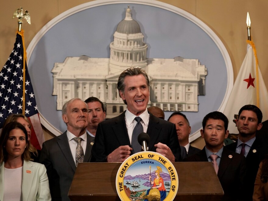 California Gov. Gavin Newsom discusses the recent mass shooting in Texas, during a news conference in Sacramento, Calif., Wednesday, May 25, 2022, flanked by lawmakers from both houses of the state Legislature.