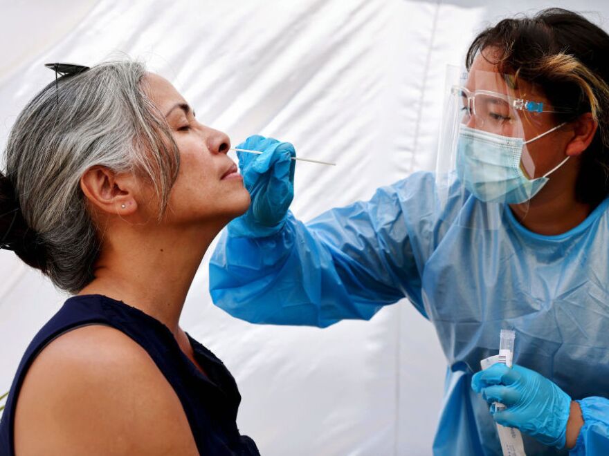 A medical assistant administers a COVID-19 test to a person at Sameday Testing on July 14, 2021, in Los Angeles. COVID-19 cases are on the rise in most states as the highly transmissible delta variant has become the dominant strain in the U.S.