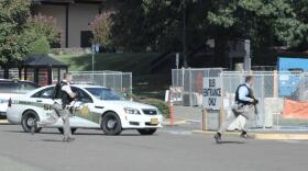 Officers run toward Snyder Hall at Umpqua Community College on Oct. 1, 2015, after initially responding to a shooting.