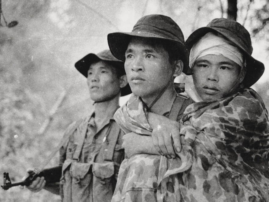 Burns explores the Vietnam War from multiple perspectives in his new documentary. Here, a Viet Cong guerrilla fighter carries a wounded friend during action along the Cambodian border.
