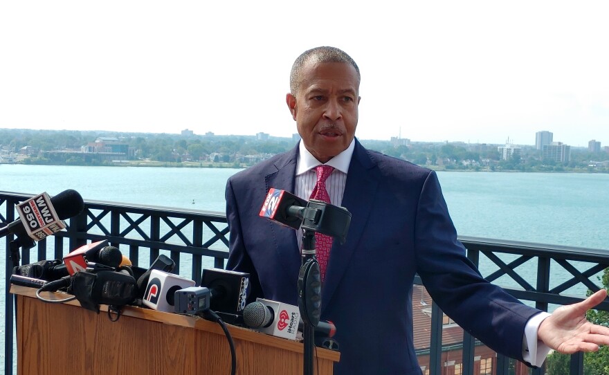 James Craig standing behind a podium outdoors