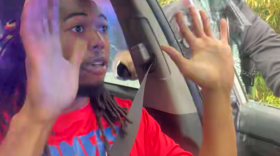 In this image take from video from what appears to be Will McNeil's X account (@904will), McNeil holds his hands up when asked by deputies before he is pulled from his vehicle and arrested on July 19, 2025.