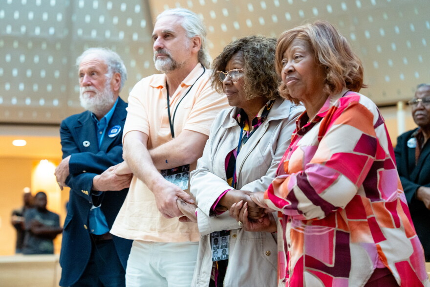 Freedom Riders and descendants, from left, Steve Thomas, Max Heller, Margaret Petway, and her sister, Kredelle Petway-Phillips, hold hands while singing at Xavier University of Louisiana in New Orleans, Wednesday, Oct. 28, 2026. (Christiana Botic/Verite News and Catchlight Local/Report for America via AP)