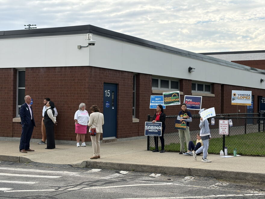 Voters and supporters gather outside Francis J. Varieur Elementary School early Wednesday morning. PAUL SINGER/OCEAN STATE MEDIA