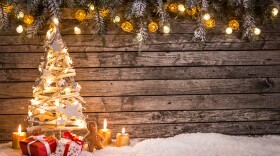 This stock photo shows Christmas decorations on a wooden background.