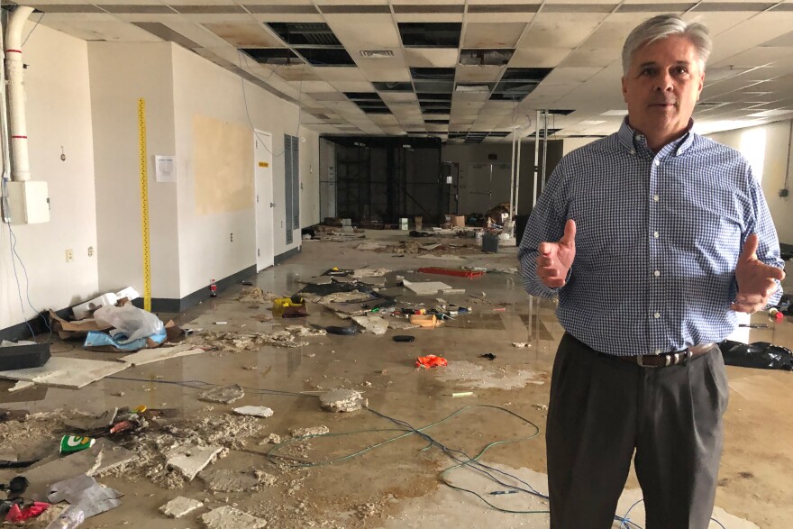 Tony Sholar of the Marine Corps stands in the abandoned headquarters of a Marine unit at Camp Lejeune, N.C. The building was damaged in Hurricane Florence, and rainwater still pours through damaged roof.