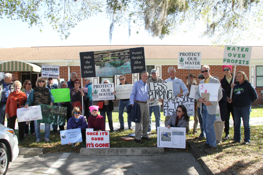 Protestors stand outside the Marion County Commission Auditorium on Thursday afternoon in a demonstration against the St. John’s River Water Management District’s proposed regulations for Silver Springs. (Dylan Dixon/WUFT News)