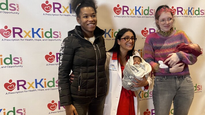 Dr. Mona Hanna-Attisha stands alongside Flint mothers and babies who are among the first to benefit from the Rx Kids cash transfer program.