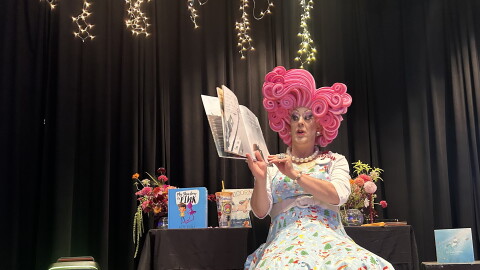 Miss Shirley reading at book at the drag queen story time in Gunnison.