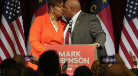 North Carolina Lt. Gov. Mark Robinson, right, Republican candidate for governor, kisses his wife, Yolanda Hill Robinson, after speaking at an election night event in Greensboro, N.C., March 5, 2024. A nonprofit operated by Yolanda Hill Robinson that she recently shuttered was "seriously deficient" in its recent operations, according to a state review examining how it carried out a federally funded meal program helping some child care providers. (AP Photo/Chuck Burton, File)