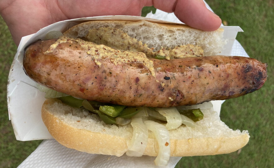  The reporter enjoys an alligator sausage po-boy at Jazz Fest on May 1, 2022.