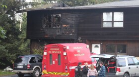 fire vehicles at a burned home