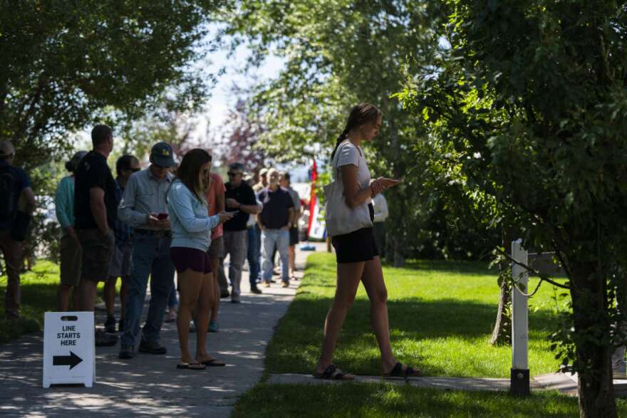 People wait in line to vote during the Republican primary election in Wilson, Wyo., Tuesday, Aug. 16, 2022. (AP Photo/Jae C. Hong)