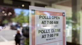 A sign displaying voting hours is placed outside a polling location during the Nevada primary election in Reno, Nevada.