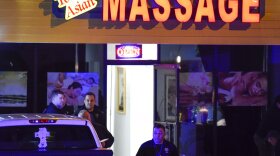 Authorities investigate a fatal shooting at a massage parlor, late Tuesday, March 16, 2021, in Woodstock, Ga. Officials say 21-year-old Robert Aaron Long, of Woodstock, Georgia, has been captured hours after multiple people were killed in shootings at three Atlanta-area massage parlors. 