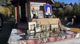 A table filled with tributes to Richard M. Richardson, creator of the "Three Sisters Sanctuary" in Goshen, Mass.
