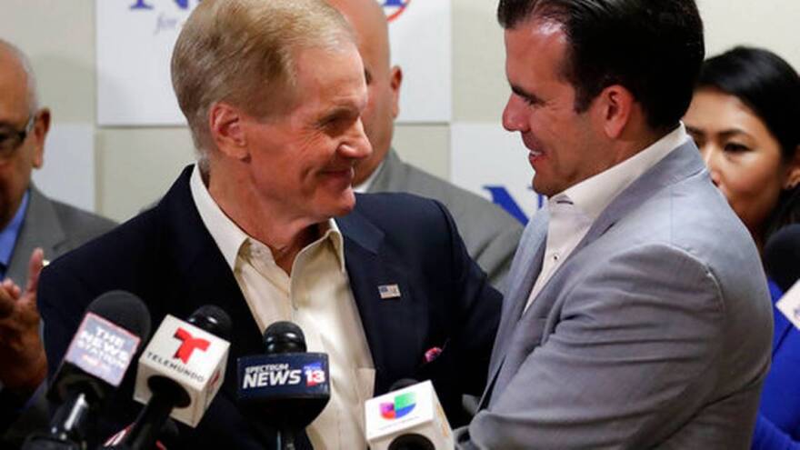 U.S. Sen. Bill Nelson, left, is embraced after Puerto Rico Governor Ricardo Rossello, right, endorsed his bid for the senate in front of supporters and media during a news conference Monday Oct. 1, 2018, in Orlando, Fla. 