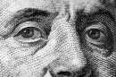 A closeup image of Benjamin Franklin's face on a $100 bill.