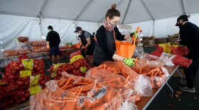 In this April 18, 2020, file photo, San Francisco-Marin Food Bank volunteers pack food into bags to be delivered to people in San Francisco. Food banks and anti-hunger advocates are bracing for the end of a pandemic-era boost in food assistance that the federal government has been providing for nearly three years.