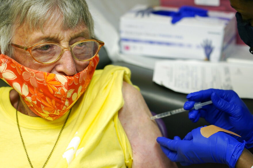 Linda Busby, 74, stiffens up as she receives a shot of the Janssen COVID-19 vaccine at the Aaron E. Henry Community Health Service Center, Wednesday, April 7, 2021, in Clarksdale, Miss. The Mississippi Department of Human Services is in the initial stages of teaming up with community senior services statewide to help older residents get vaccinated. (AP Photo/Rogelio V. Solis, File)