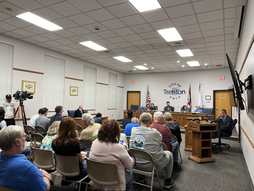 People sit in folding chairs facing the Trenton Planning Commission.