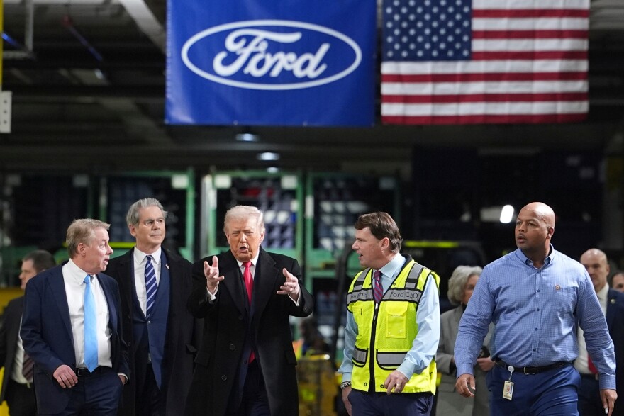 President Donald Trump speaks to, from left Bill Ford, Executive Chairman of Ford, Treasury Secretary Scott Bessent, Jim Farley, CEO of Ford, and Corey Williams, Ford River Rouge Plant Manager, during a tour of the Ford River Rogue complex, Tuesday, Jan. 13, 2026, in Dearborn, Mich. (AP Photo/Evan Vucci)