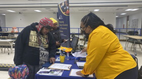 Former HIM By HER parent Samone Curry talked to an employee with Indy STEAM Academy during a school enrollment at HIM By HER Collegiate School for the Arts, which will close in January 2023.