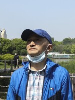 Zhang Hai stands on a bridge where he took his father out for a walk only about four months earlier. His father died of the novel coronavirus on Feb. 1. "The scenery is still here, but the person is gone," he sighs. He says he frequently comes to this park "looking for memories."