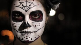 Michele Lis, University of Florida medical anthropology senior, shows off her Halloween costume at FEST on Bo Diddley Plaza in Gainesville, Florida, on Friday.