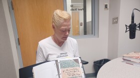 Kathryn Vicat with Footsteps Researchers holds a binder she compiled with information about Native Americans who fought in WW II and whose names were embroidered on a quilt (photo taken in July, 2024).