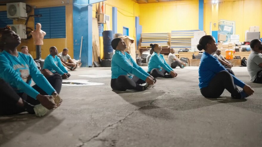 Pictured: Officers and community members take part in early morning stretches during the department’s public workout initiative, held Monday-Friday at 5:30 a.m.
