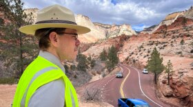 Jonathan Shafer of Zion National Park watches vehicles approach a sharp turn on the Zion-Mt. Carmel Highway, March 19, 2024. The risk of collisions with curves like this one is a big part of why the park decided to start prohibiting oversized vehicles from the road.