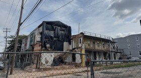 The three-story apartment complex at 501 North 8th St. in Reading remained fenced off July 18 after the south wall collapsed July 5. (Hanna Holthaus / Spotlight PA)