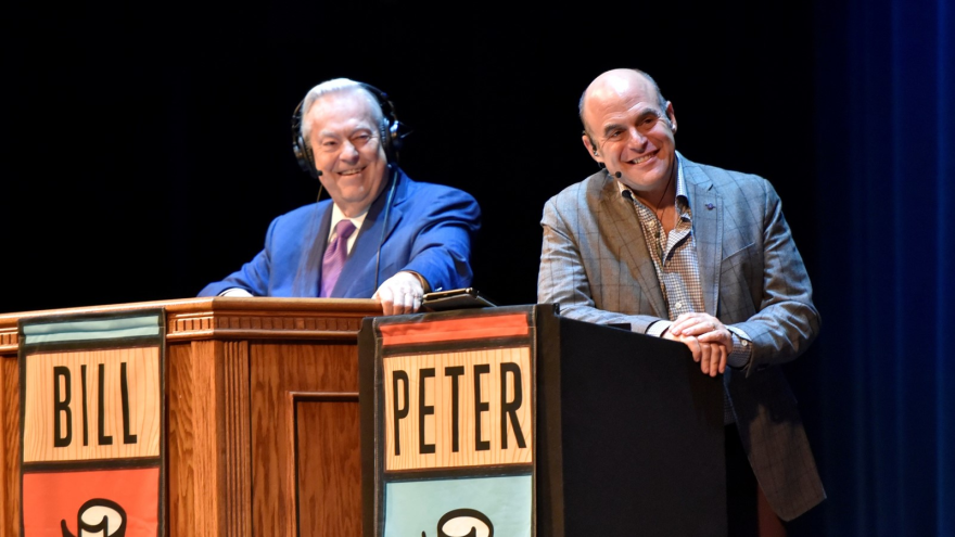 Bill Kurtis and Peter Sagal, laughing at the week’s news during a live taping of Wait, Wait . . . Don’t Tell Me!