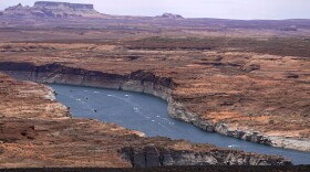 FILE - Boats move along Lake Powell along the Upper Colorado River Basin, June 9, 2021, in Wahweap, Ariz. In Arizona, water officials are concerned, though not panicking, about getting water in the future from the Colorado River as its levels decline and the federal government talks about the need for states in the Colorado River Basin to reduce use.