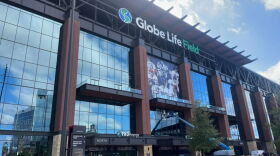 Workers at Globe Life Field paste a large World Series poster onto the side of the stadium on Oct. 26, 2023, a day before the Texas Rangers host the 2023 World Series. <br/><br/>